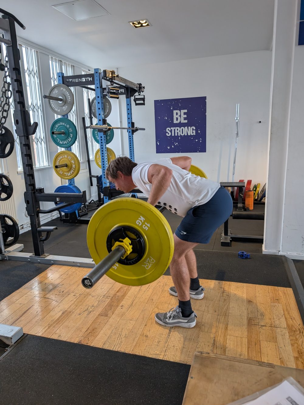 Real World Fitness personal training client learning a Pendlay row in the gym