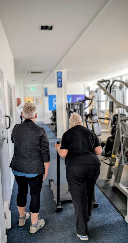 RWF PT Christine helping an older client learn to walk again