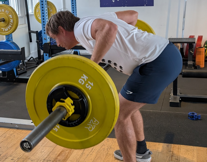 Real World Fitness personal training client learning a Pendlay row in the gym