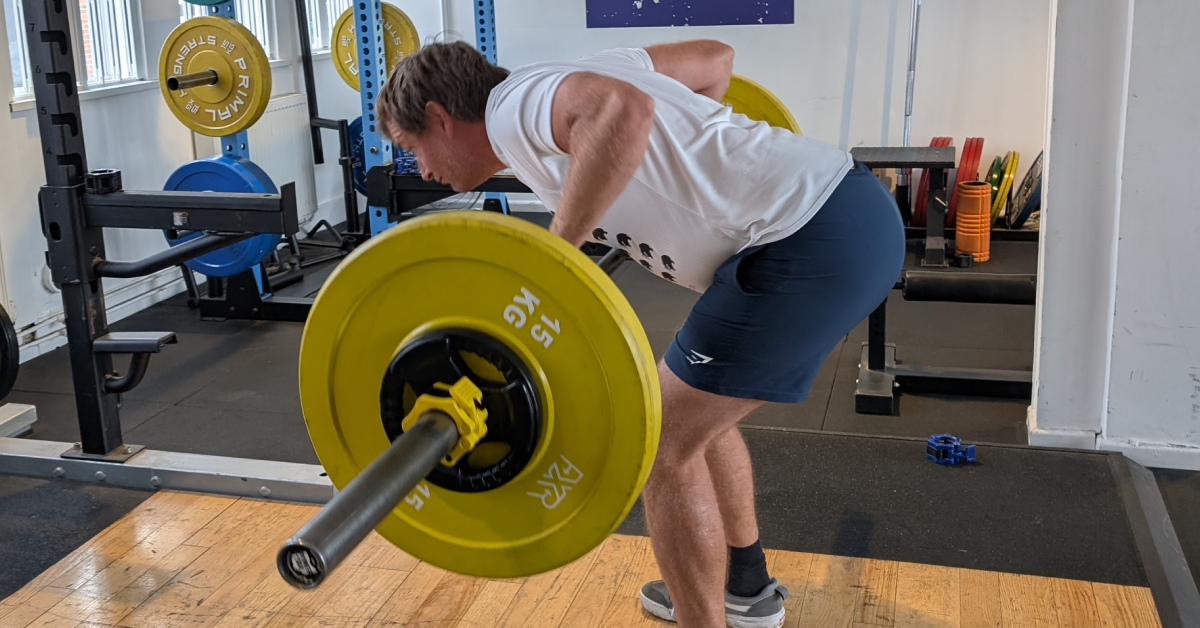 Real World Fitness personal training client learning a Pendlay row in the gym